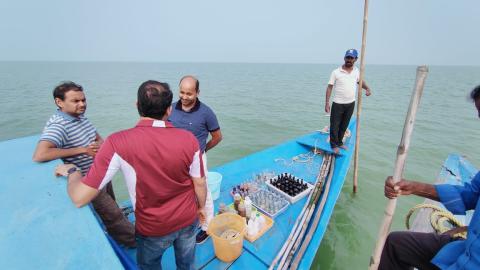 Project team on boat taking water samples from Chilika Lake.